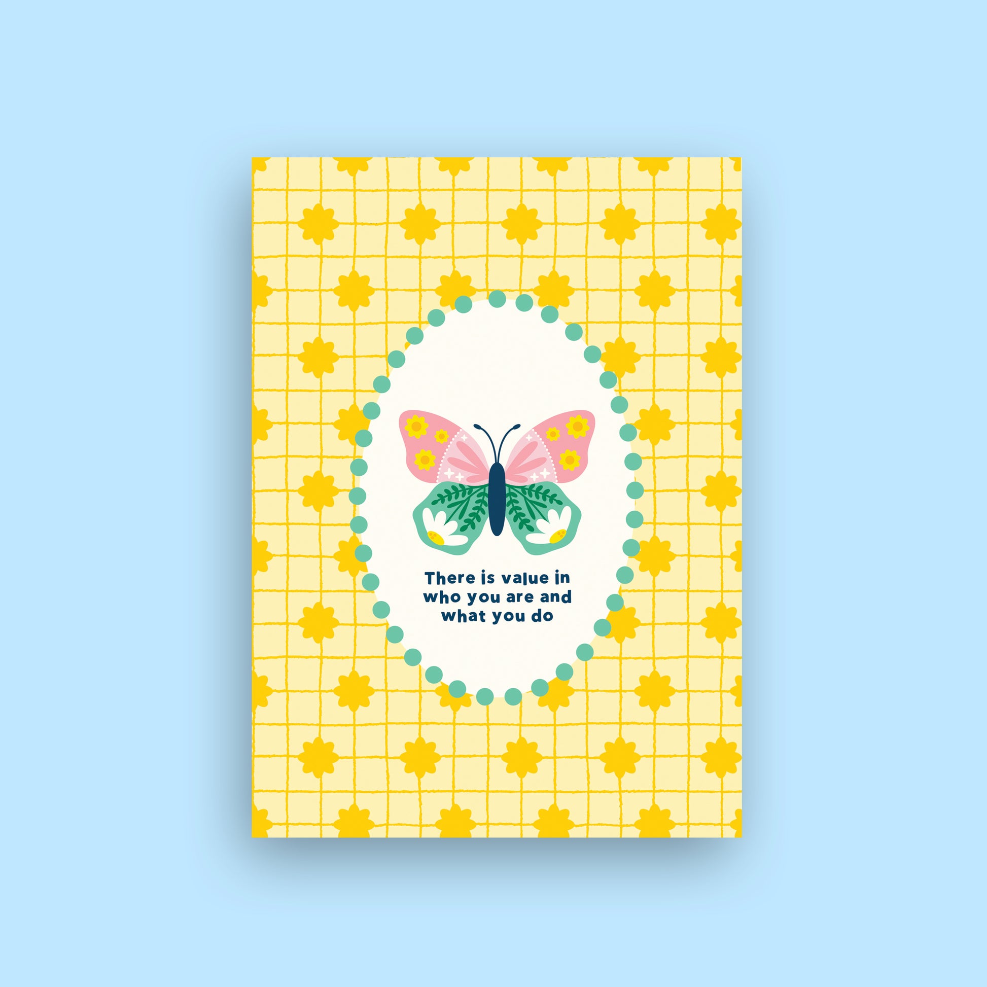 A yellow greeting card with a grid pattern, yellow sun motifs, and a central white oval containing a colorful butterfly and the quote 'There is value in who you are and what you do'. The card is shown against a solid light blue background.