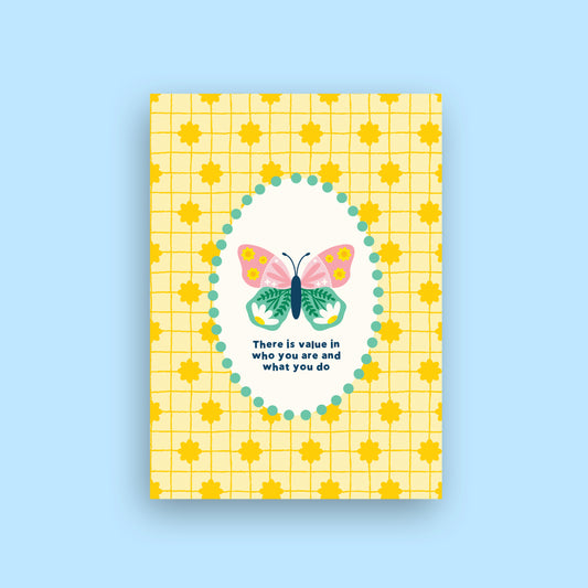 A yellow greeting card with a grid pattern, yellow sun motifs, and a central white oval containing a colorful butterfly and the quote 'There is value in who you are and what you do'. The card is shown against a solid light blue background.